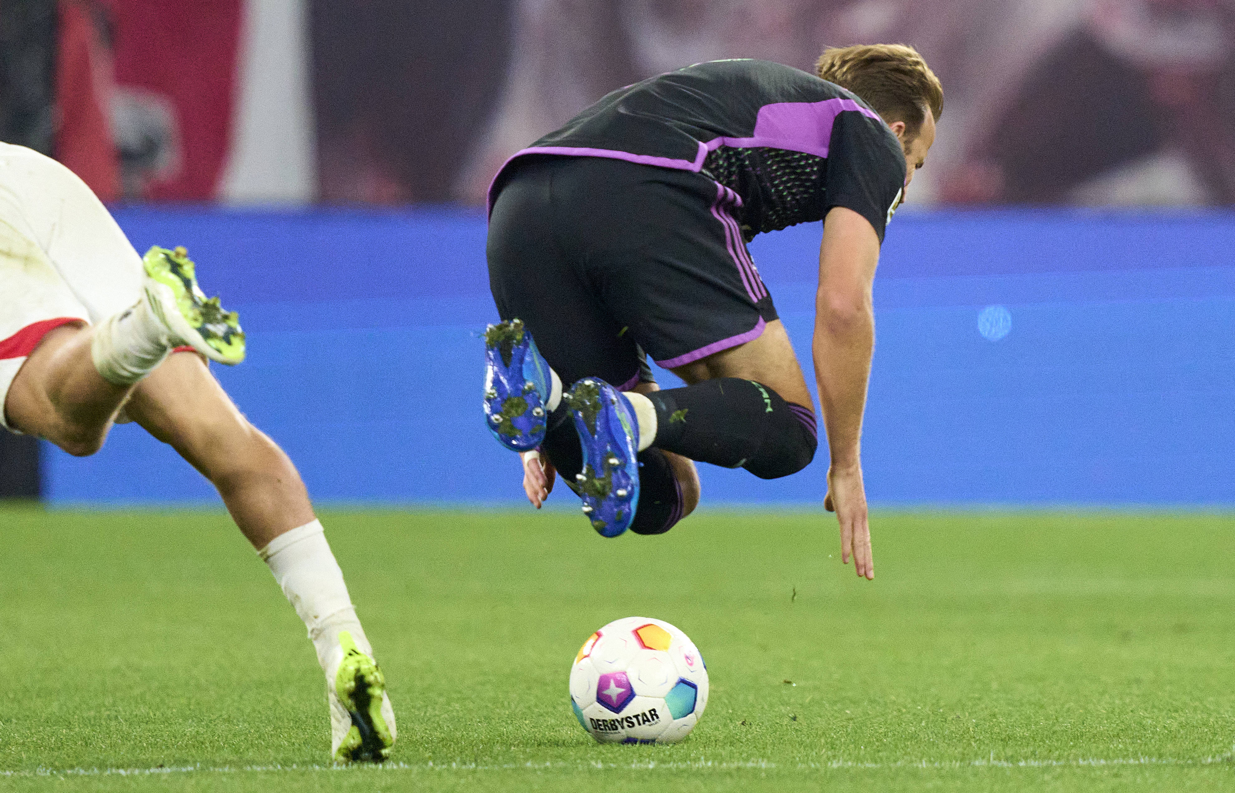 Harry Kane pictured falling over following a challenge with Xaver Schlager during Bayern Munich's 2-2 draw with RB Leipzig in September 2023